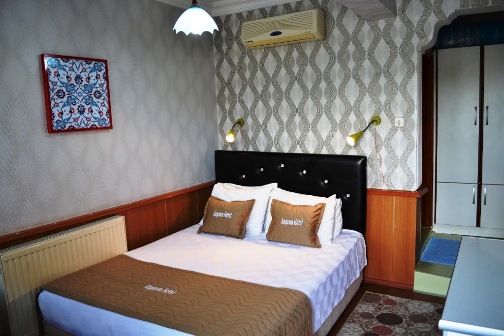Giường trong phòng chung tại Aspawa Hotel