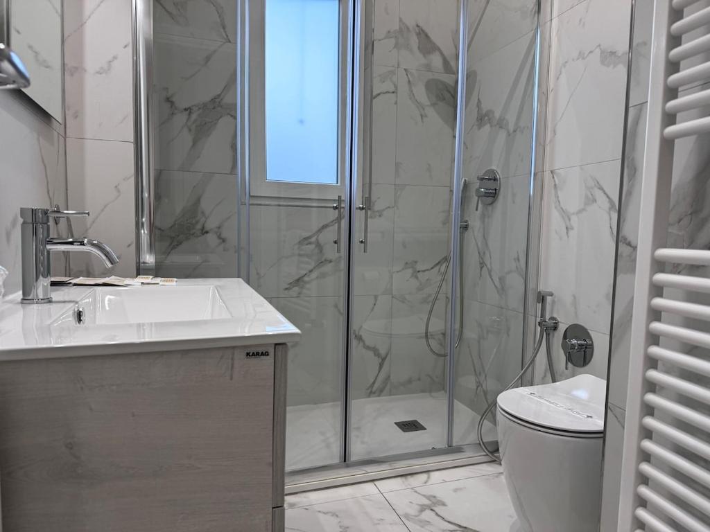 a bathroom with a shower and a sink and a toilet at a casa di Luca in Florence