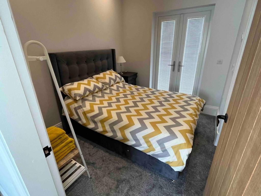 a bedroom with a bunk bed with a yellow and white comforter at 4 Mulberry Green , Waterfoot , Rossendale, Lancs in Newchurch