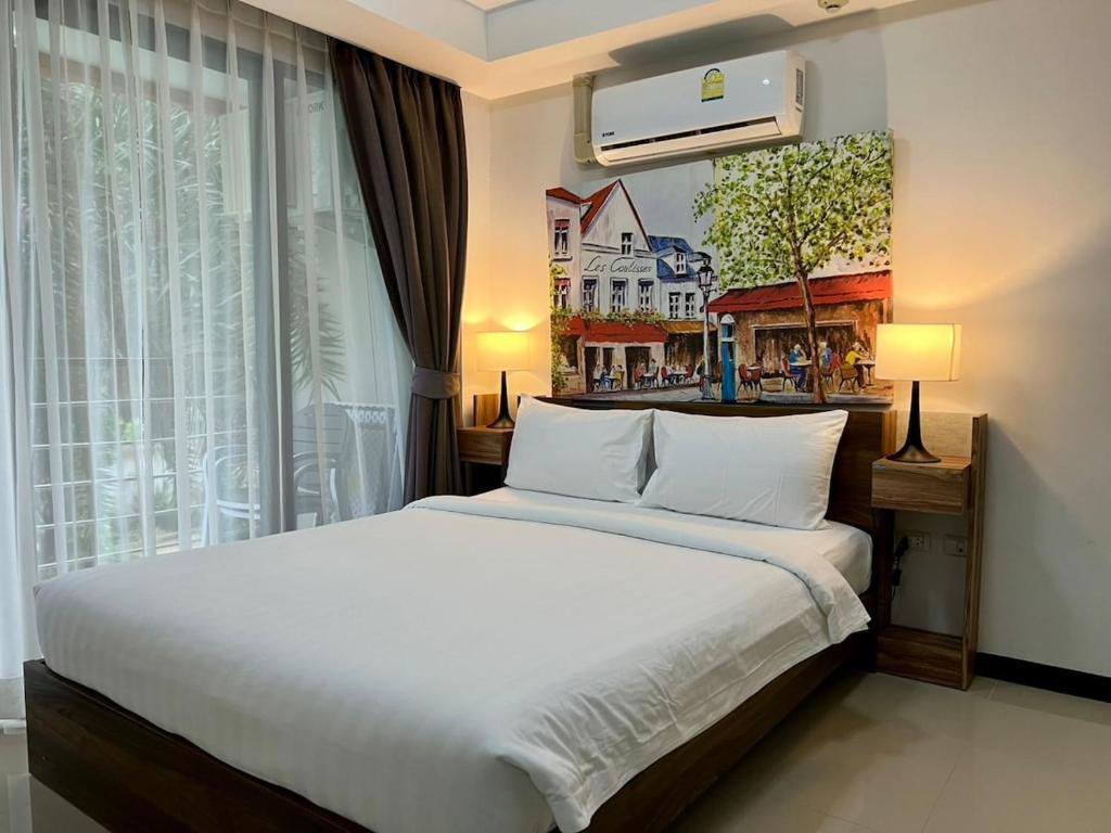 Ένα ή περισσότερα κρεβάτια σε δωμάτιο στο Cozy Condotel Maikhao
