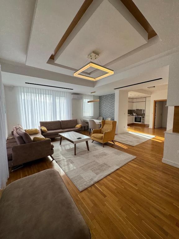 a large living room with a couch and a table at Riga Lux Apartment Prishtina in Pristina