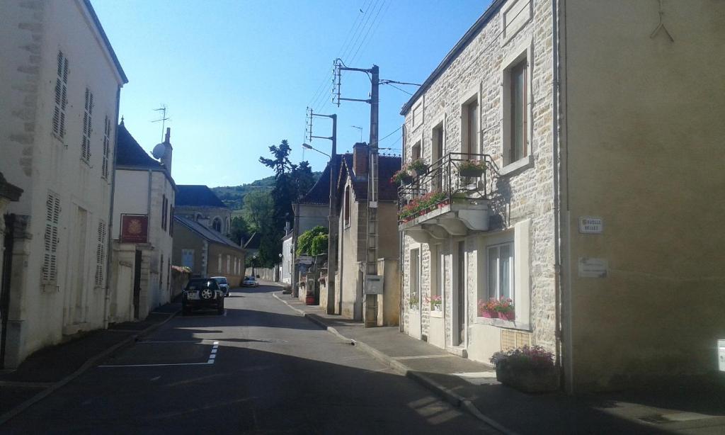 an empty street in a small town with buildings at Chez Laurence in Santenay