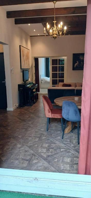 a living room with a table and chairs and a bedroom at Gouda city center apartment with private garden and 2 bicycles in Gouda