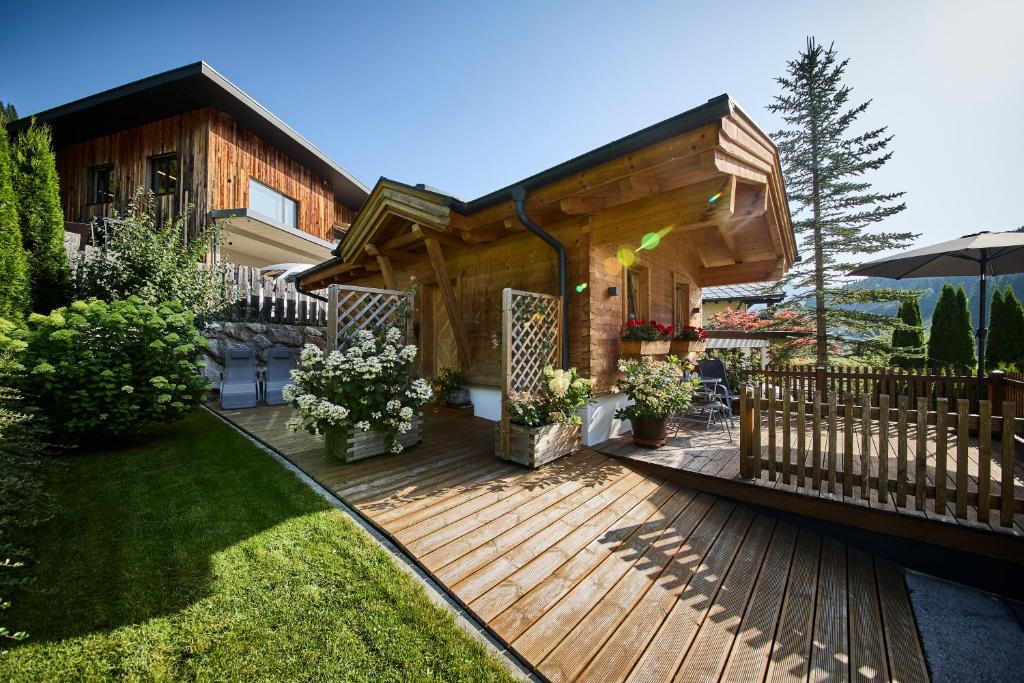 a wooden deck in front of a house at Haus Silian - Studio in Saalbach-Hinterglemm