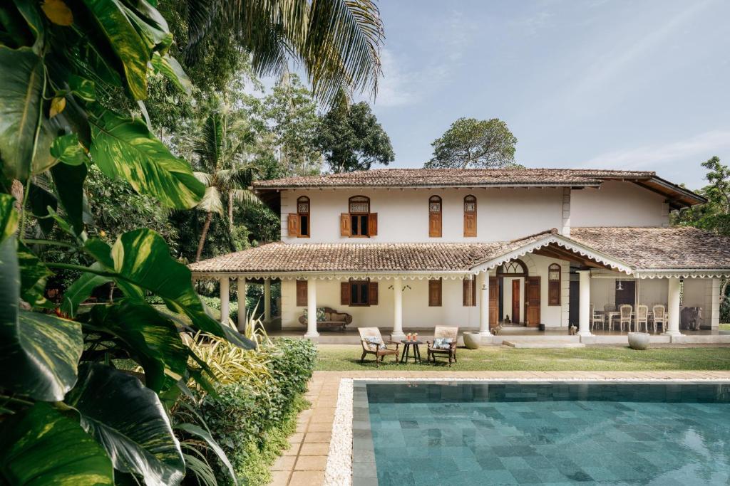 a house with a pool in front of it at Kalukanda House in Weligama