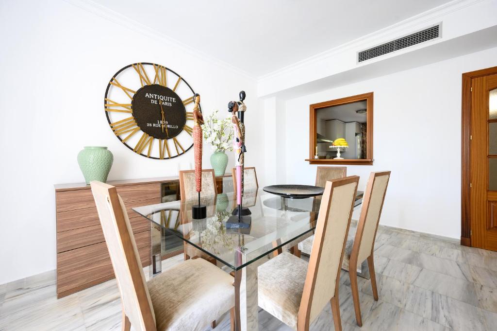 a dining room with a glass table and chairs at VILLA INTMA - GOLF - POOLS - near Mijas, Marbella, Fuengirola - Fully Equipped in Alhaurín el Grande
