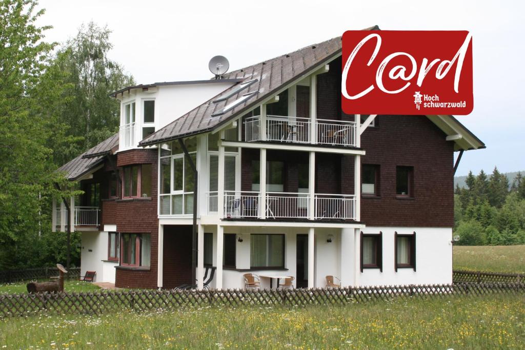 a large building with a cocacola sign in front of it at Seewiese 01 Seeblick mit Hochschwarzwald-Card in Titisee-Neustadt