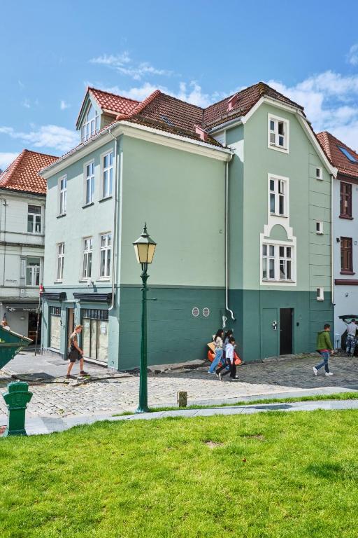 a group of people walking in front of buildings at HD Central Topfloor in Bergen