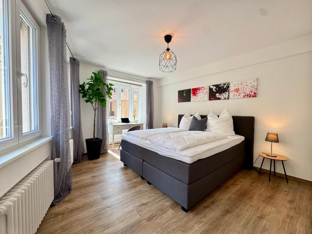 a bedroom with a large bed and a window at Corner Loft - Altstadt Design Apartment in Freiburg im Breisgau