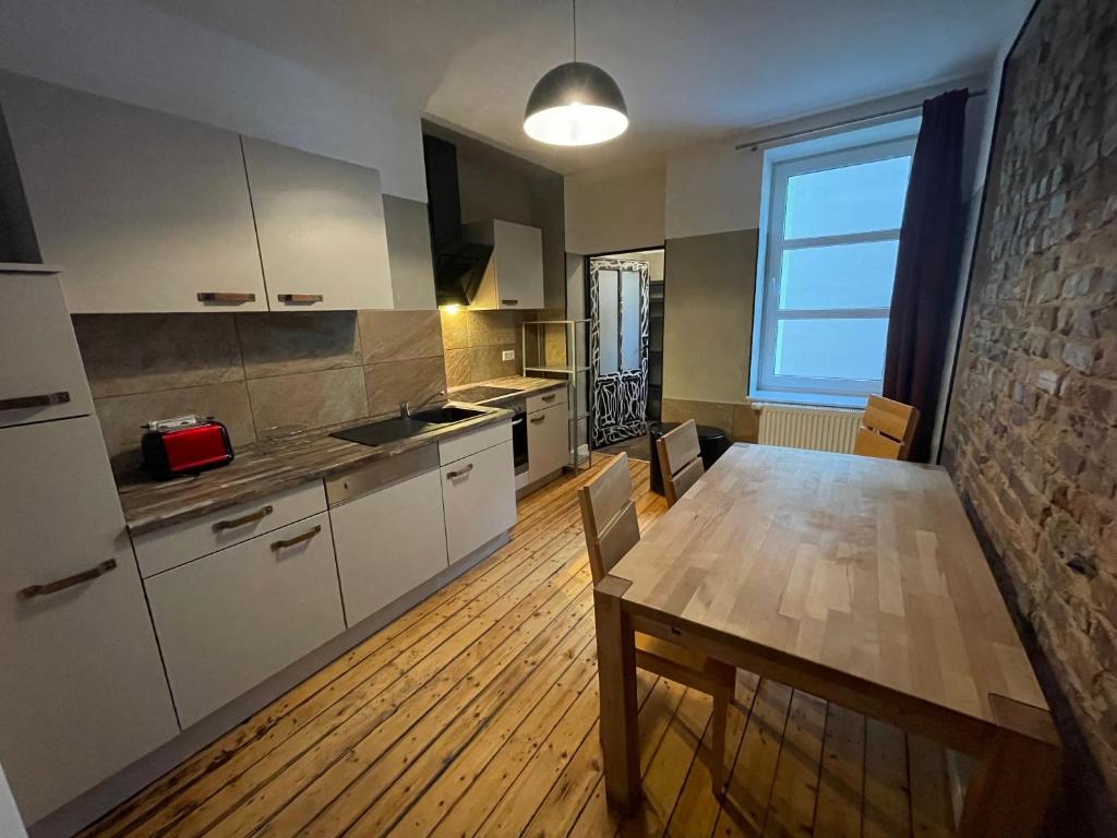 a kitchen with a wooden table and a dining room at Apartment B34 in Bielefeld