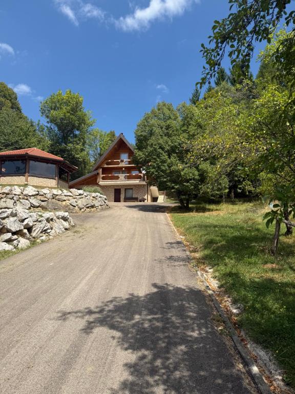 a dirt road in front of a house at Wolf House in Korenica