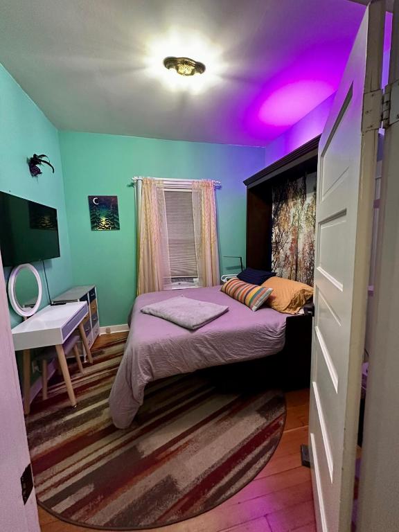 a bedroom with two beds and a purple ceiling at Room at 4114 in Seattle