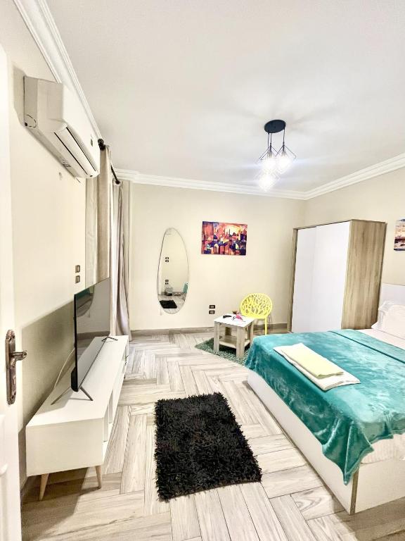 a bedroom with a bed and a table at Rose Room in Cairo