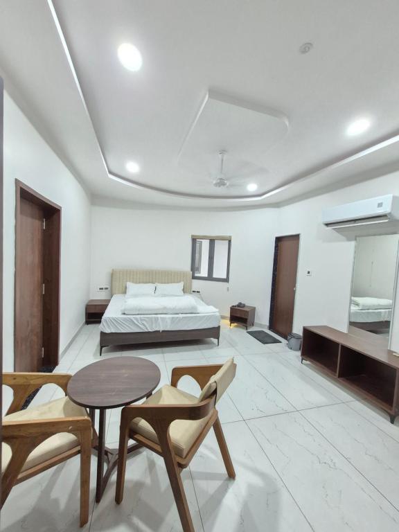 a bedroom with a bed and a table and chairs at HK Resort 