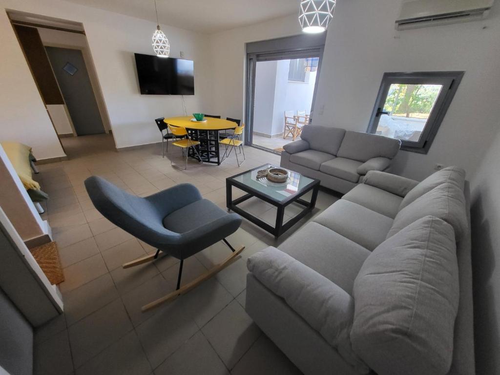 a living room with a couch and a table at Vila Pejic Xenia beach in Paliouri