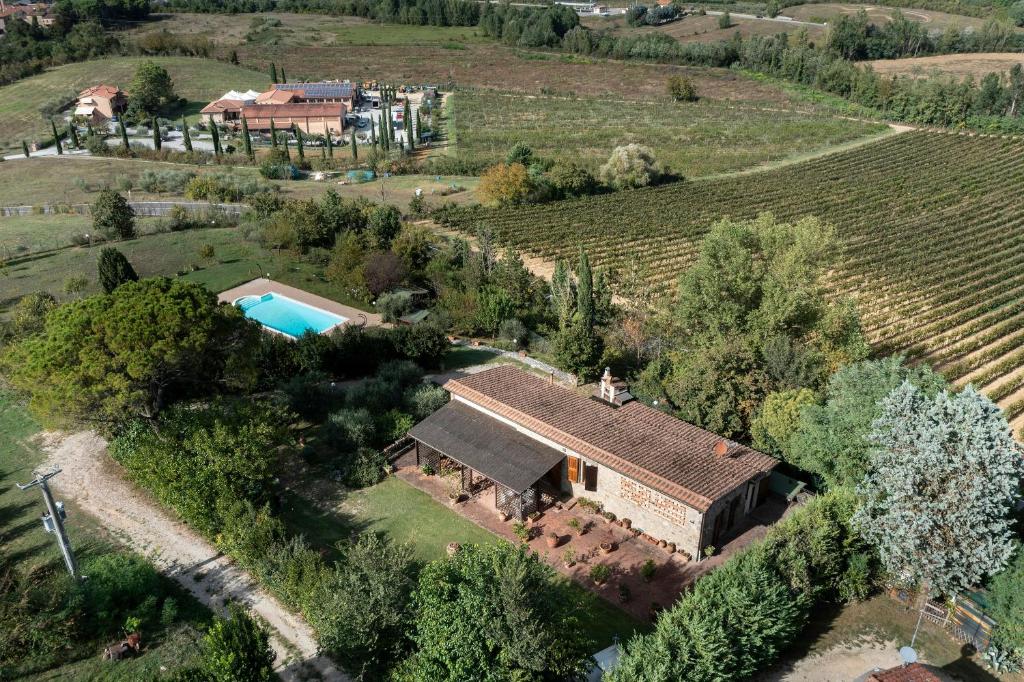 an aerial view of a house in a vineyard at Historic Villa With Pool In The Heart Of Chianti in Monteriggioni