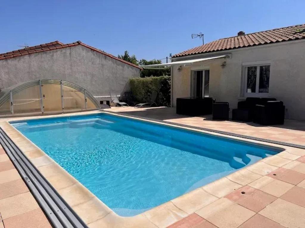 a swimming pool in front of a house at Villa accueillante à Saint-Froult avec piscine privéeB in Saint-Froult