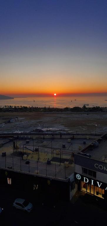 a view of a parking lot with the sunset in the background at 3 bedrooms Sea View Akid Lotfi in Bir el Djir