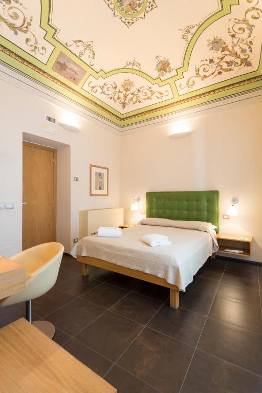 Postel nebo postele na pokoji v ubytování Hotel Novecento