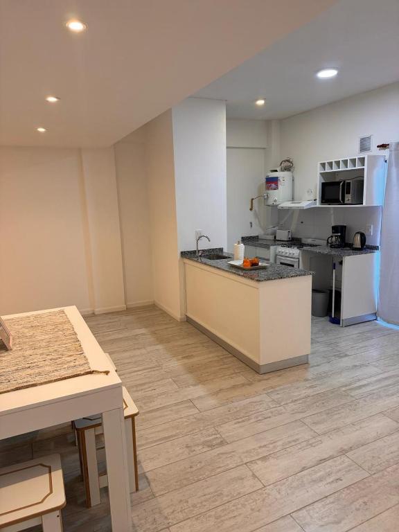 a large kitchen with a counter in a room at Urbanstay in Villa Constitución