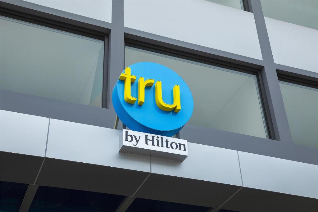 a sign on the side of a building with the ups logo at Tru by Hilton Nam Dinh City Centre in Nam Ðịnh