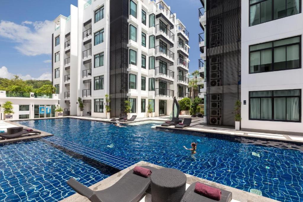 a swimming pool in the middle of a building at Kamala Regent in Kamala Beach