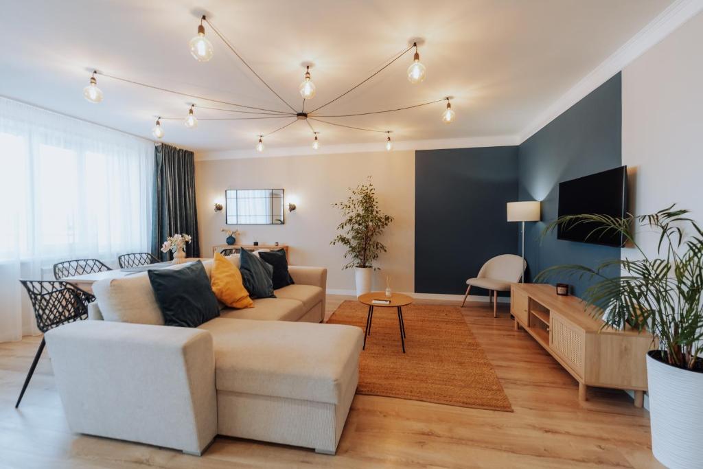 a living room with a couch and a table at Luxury 2BR Flat Sauna & Living Cathedral Nearby in Chişinău