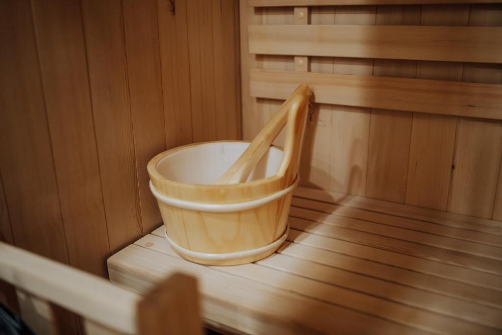 a bucket sitting in the inside of a sauna at Luxury 2BR Flat Sauna & Living Cathedral Nearby in Chişinău
