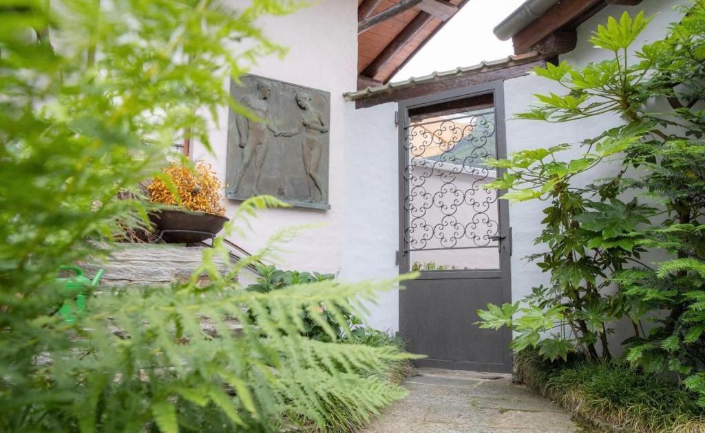 a front door of a white house with a window at Haus San Cristoforo Atelier in Maggia