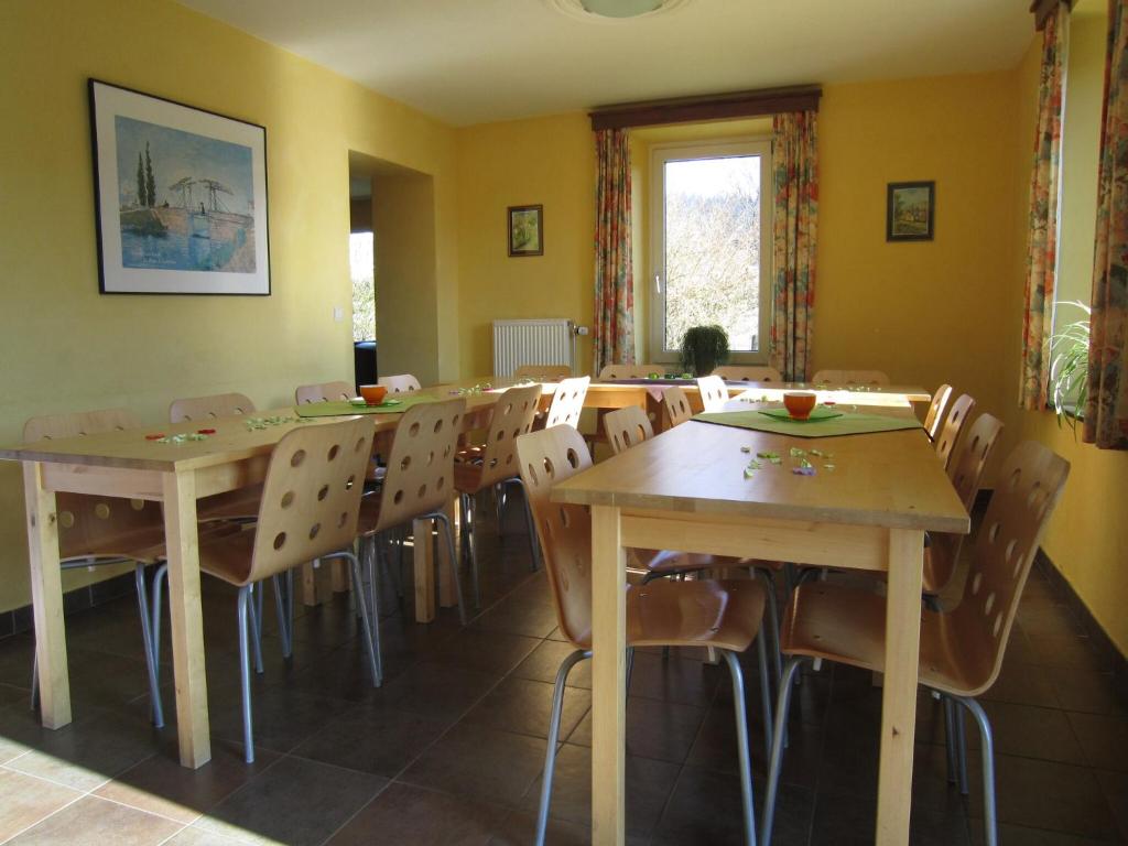 a dining room with wooden tables and chairs at Home in Vielsalm with Sauna in Vielsalm