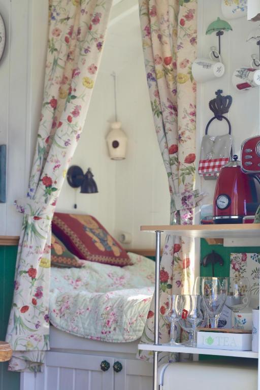 a bedroom with a bed with curtains and a table at Lulla Cottage in Lulla