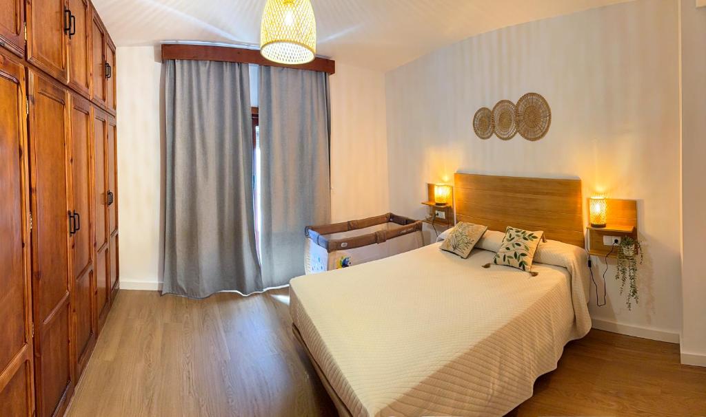 a bedroom with a bed and a large window at Alojamiento Rural Ciudad Monumental in Baeza