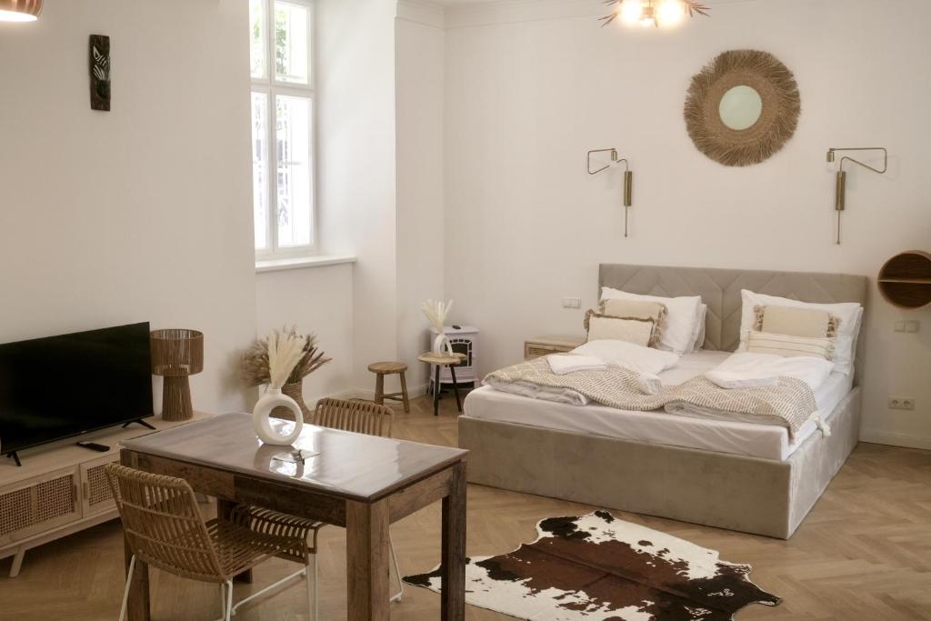a bedroom with a bed and a table and a tv at City Stay Vienna – Stephansdom in Vienna