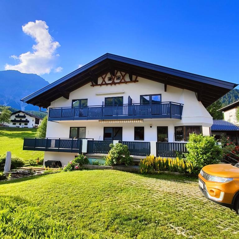 a large white building with a large yard at Sonnenbichl in Berwang