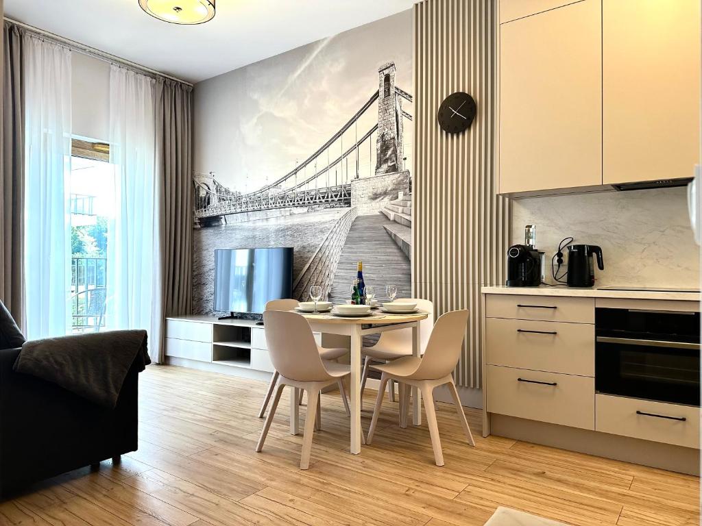 a kitchen with a table with a drawing of a bridge at Michalczyka 3A - Self Check-In 20h - Parking in Wrocław