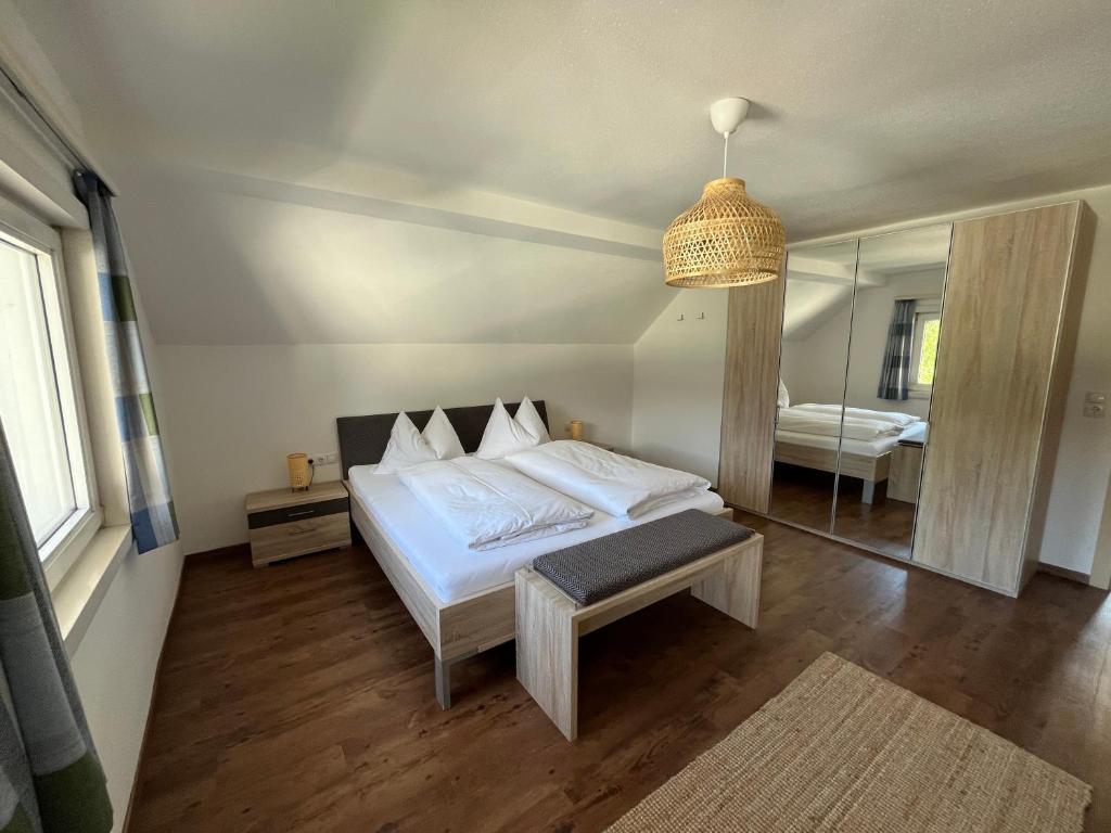 a bedroom with a bed and a table and a mirror at Appartements Luna in Schladming