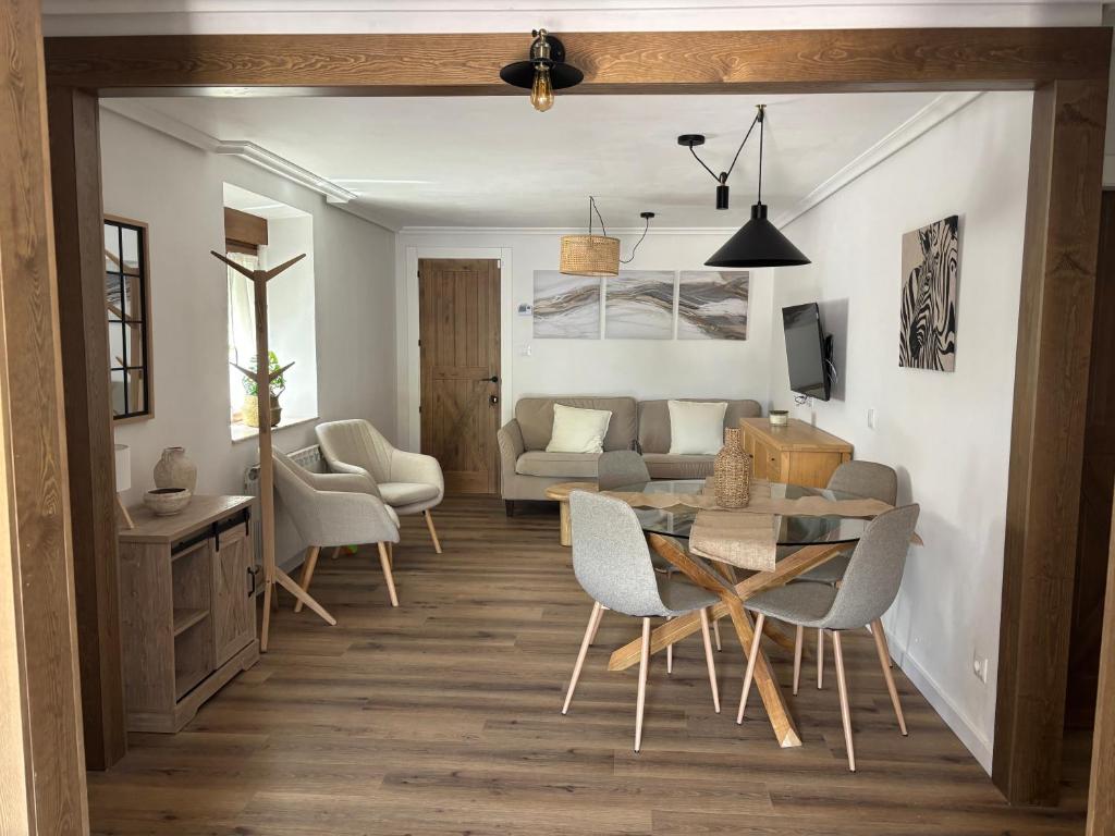 a living room with a table and chairs and a couch at El Refugio de los Corrales in San Mateo