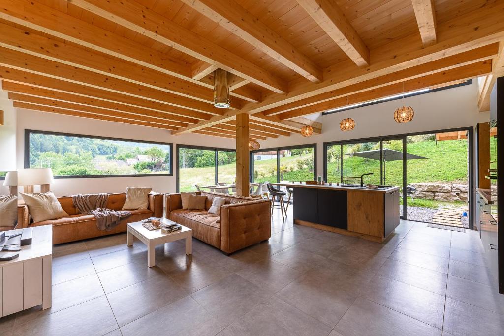 ein Wohnzimmer mit Sofa und Tisch in der Unterkunft Villa Alésia - Jacuzzi et vue montagnes, environnement apaisant in Saint-Eustache