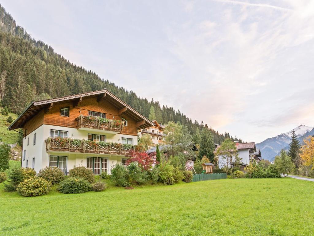 a house in the mountains with a green field at Apartment Grossarl near Ski Slopes in Grossarl