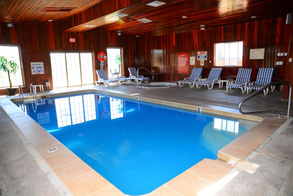 a large swimming pool with chairs in a building at Budget Inn Express in Gillette