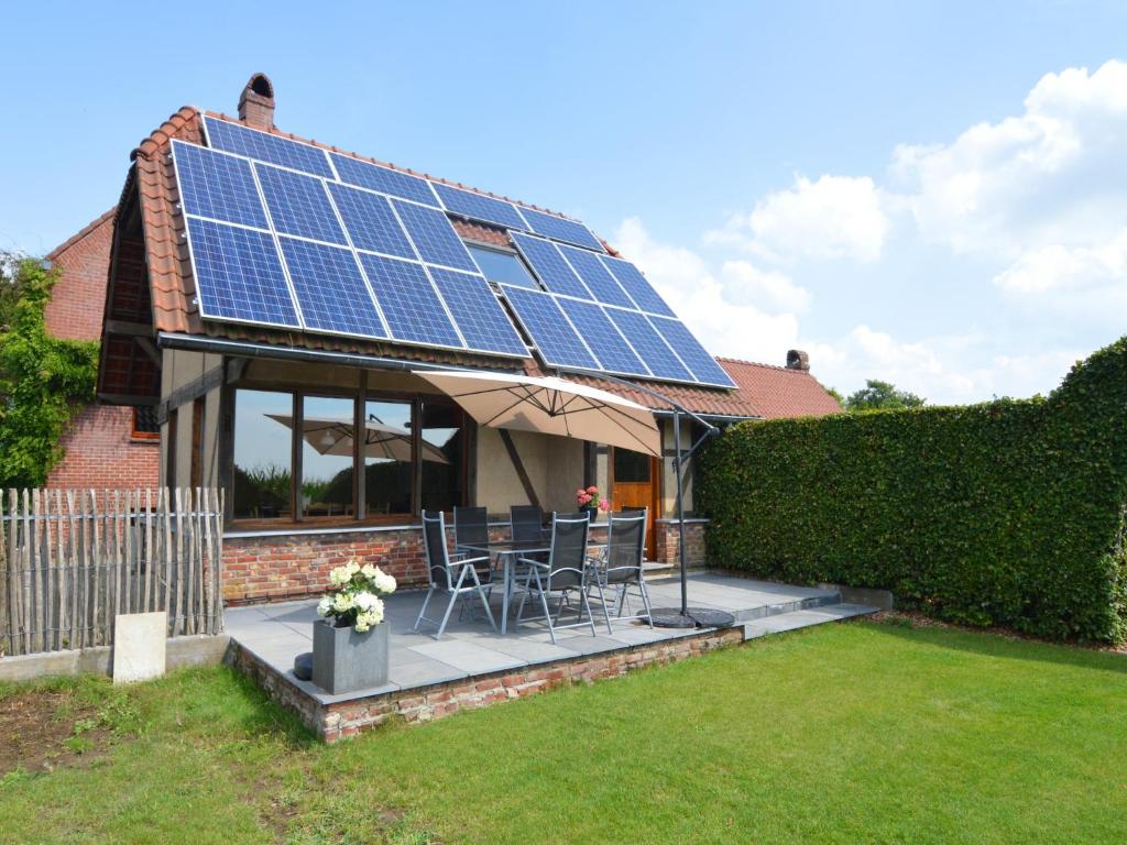 a house with solar panels on the roof at Comfortable Home with Sauna in Flobecq