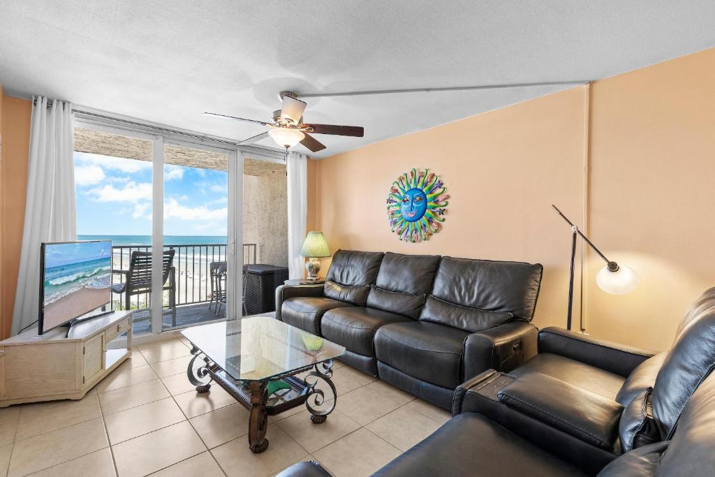 a living room with a couch and a table at Oceania Plaza 808 in New Smyrna Beach