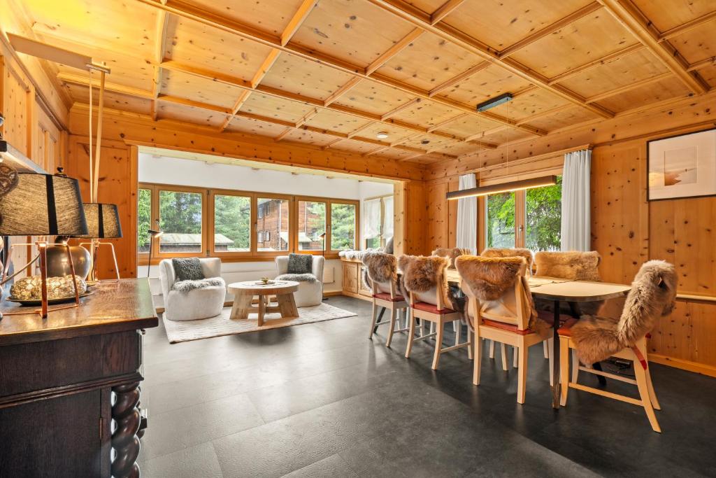 a living room with a table and chairs at A&Y Chalet Davos Central in Davos
