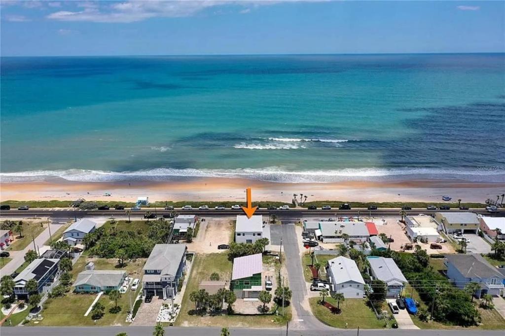 an aerial view of a beach with a yellow arrow at Bombora Suites #202 | Flamingo Suite in Flagler Beach