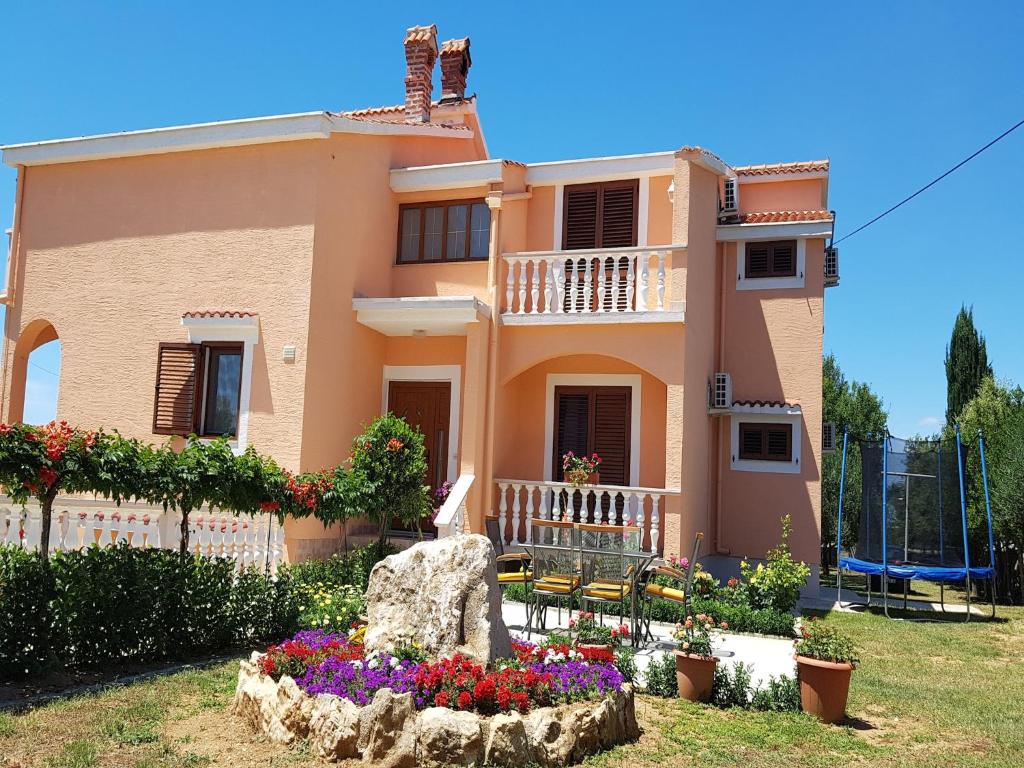 a house with a garden in front of it at Apartment in Vrsi near the Sea in Vrsi