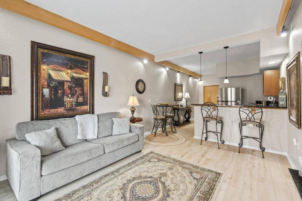 a living room with a couch and a kitchen at 301 Tuscan Breeze Getaway | Palm Coast in Palm Coast