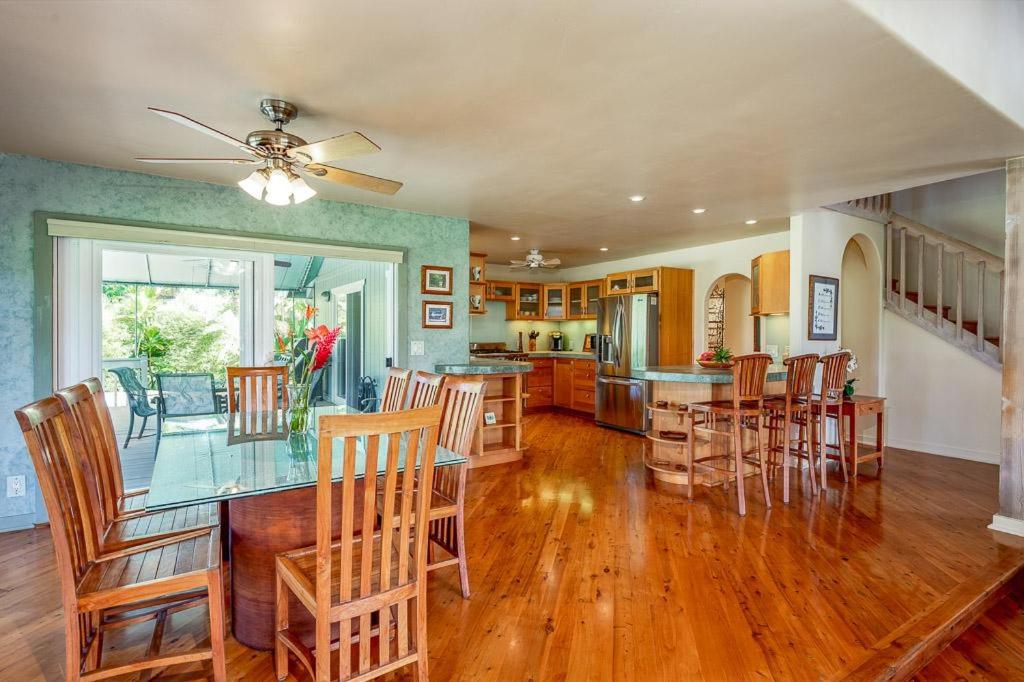 a kitchen and dining room with a table and chairs at Paradiso Hale in Princeville