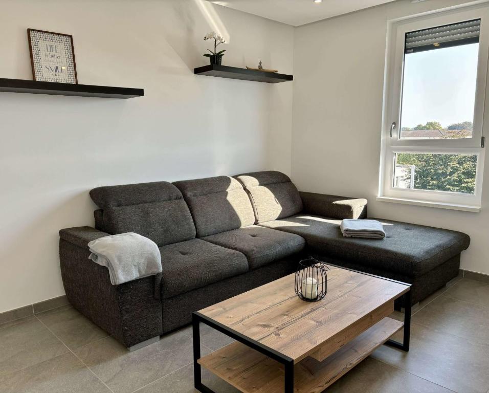 a living room with a couch and a coffee table at Air-conditioned Apartment with terrace in Illkirch-Graffenstaden
