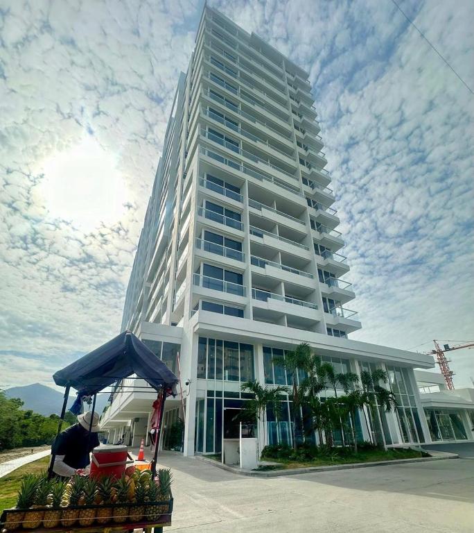 a man standing in front of a tall building at Porto Horizonte Suite 1120 in Santa Marta