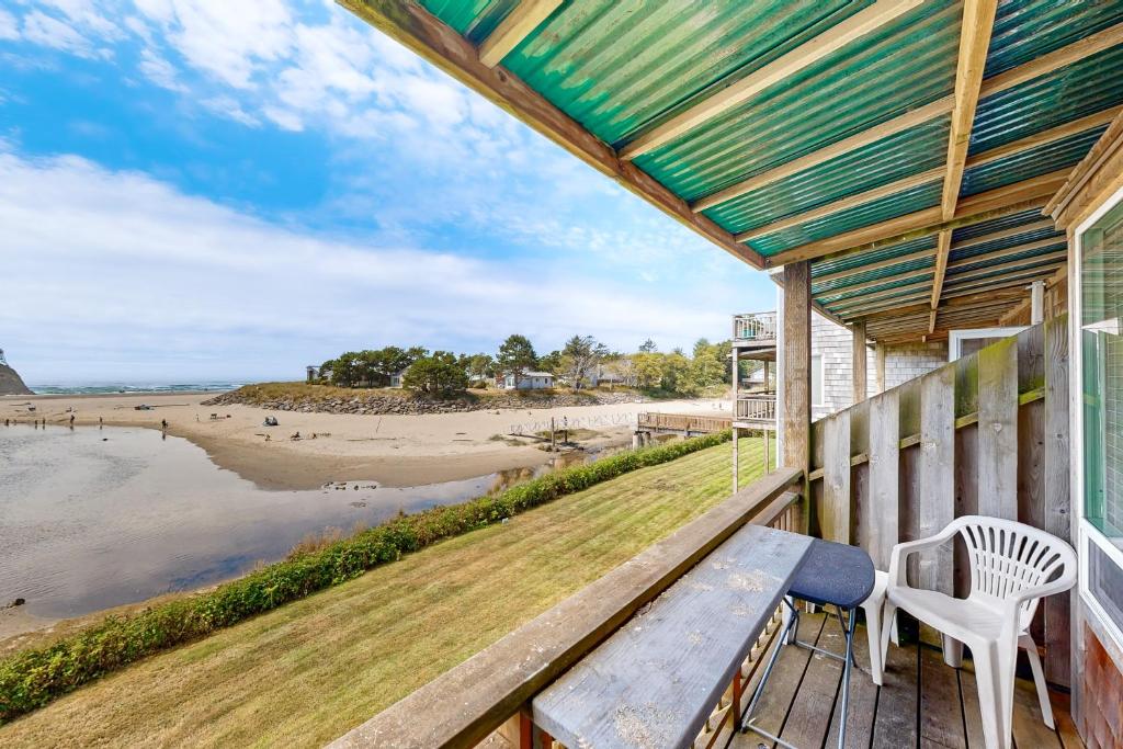 a porch with a bench and a view of the beach at Neskowin Resort Unit #203 in Neskowin